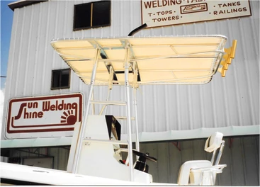 Sunshine Welding's original shop building with a boat and T-top out front, 1972